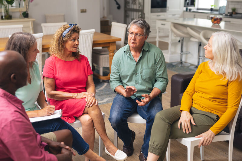 A family-style group having a calm conversation in a warm interior