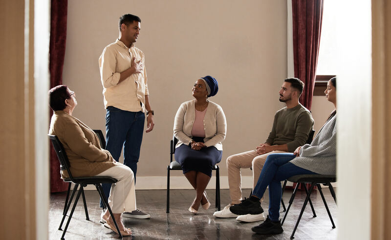 A clinician guiding a small group through a structured conversation